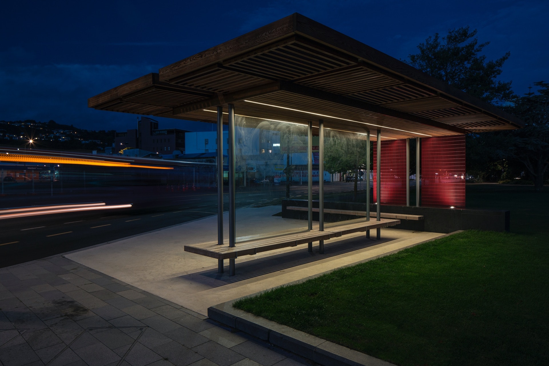 Contemporary illuminated transit shelter at night